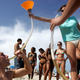 College student bonging beer on the beach